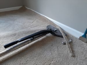 75% complete stretching carpet using a power stretcher.